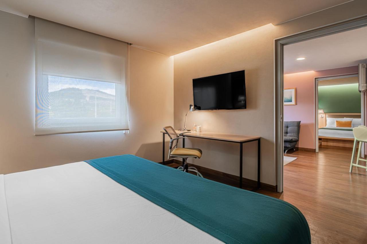 Two-Bedroom Suite with One King and Two Double Beds with Sofa Bed and Kitchenette